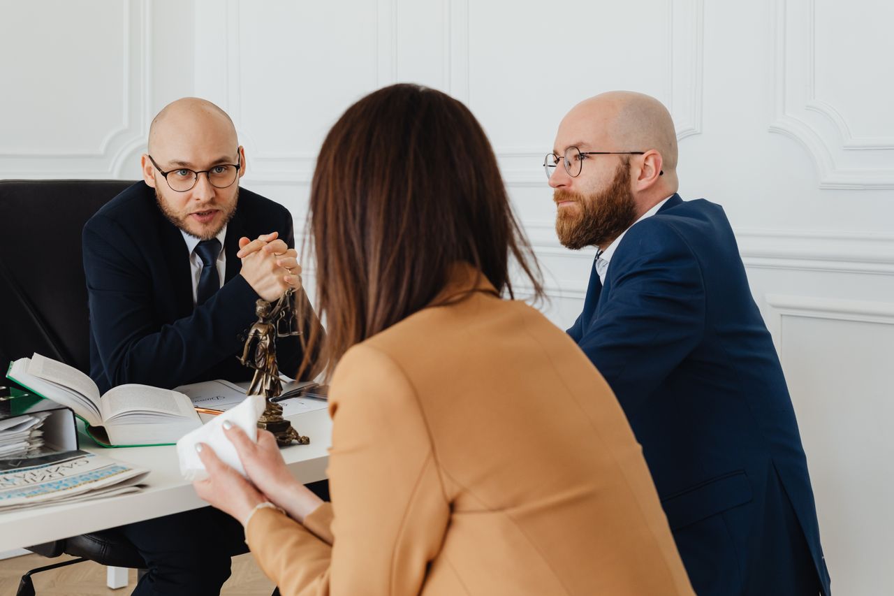 Services Professional discussion among lawyers in a modern office, focusing on legal matters.